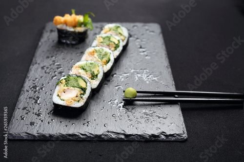 Sushi. Sushi roll with salmon, cucumber, cheese, kampyo and avocado slices. photo