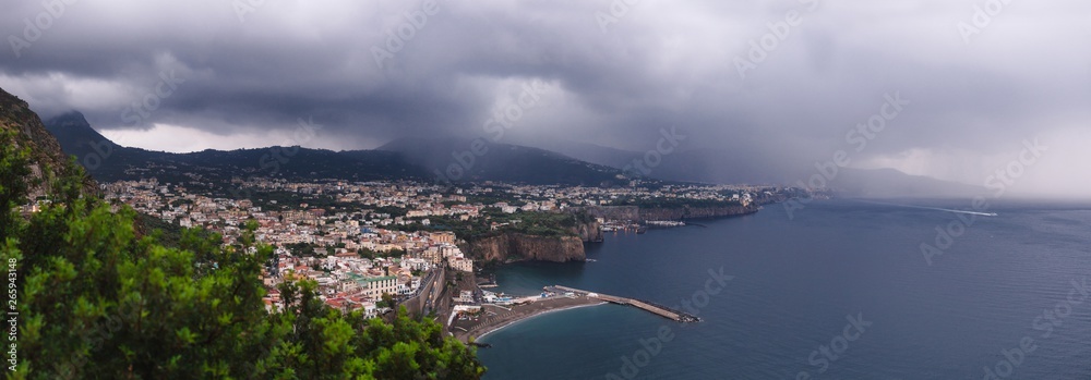 hotel on the edge of the mountain, with a view to the sea Rain clouds over beautiful Sorrento, Meta Bay in Italy, travel and vacation concept, copy space, Europe large panorama view
