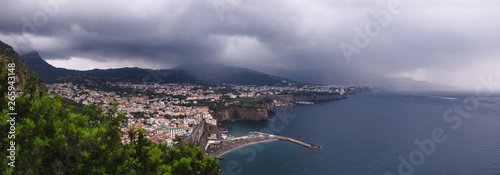 hotel on the edge of the mountain, with a view to the sea Rain clouds over beautiful Sorrento, Meta Bay in Italy, travel and vacation concept, copy space, Europe large panorama view © Sergey