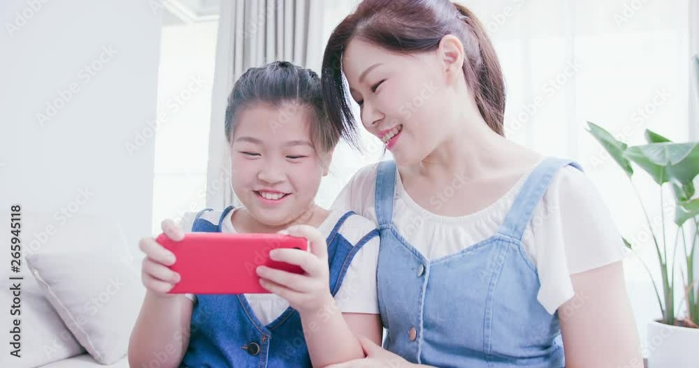 Daughter and mom use smartphone Daughter and mom use smartphone