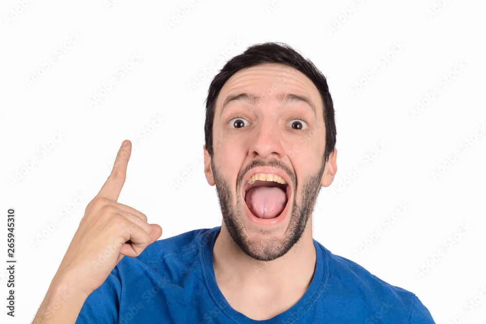 Young man shocked pointing up.