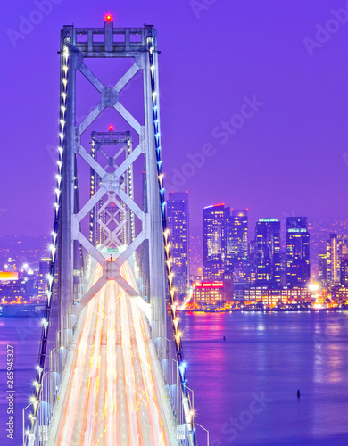 Photography View of Bay Bridge across San Francisco Bay with lots of cars passing through in San Francisco at night