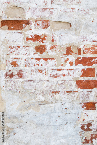 Old grunge brick concrete wall with cracked plaster texture background