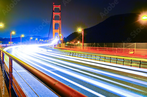Photography View of Golden Gate Bridge with lots of cars passing through in San Francisco at night