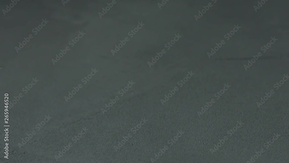 Slow motion shot of decorative dark concrete surface, shot handheld Slow motion shot of decorative dark concrete surface, shot handheld