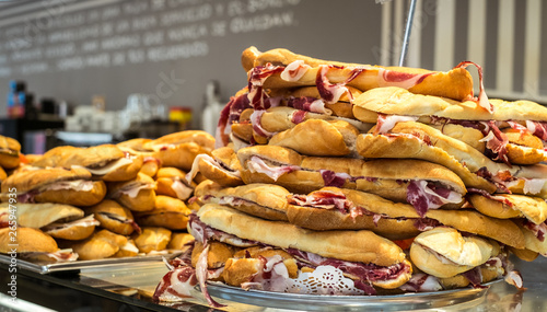 French loaf with traditional Spanish jamon Iberico on the tray photo