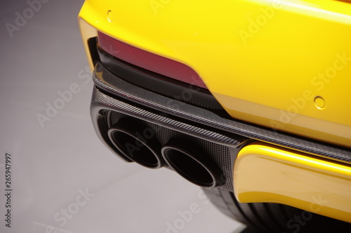 Yellow modern SUV car exhuast pipes and carbon fiber components photo