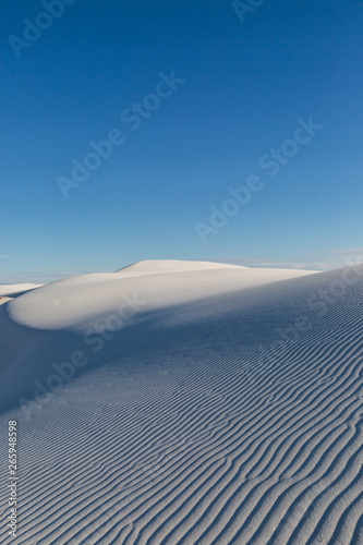 Fototapeta Naklejka Na Ścianę i Meble -  Rippled sand dunes with evening light, at White Sands National Monument New Mexico