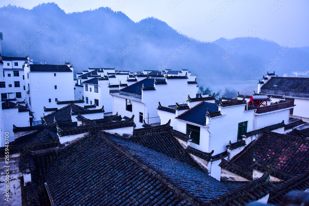 Chinese Traditional Characteristic Mountain Village Architectural Landscape in Morning Fog