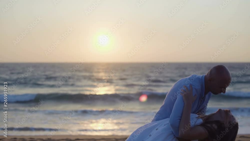Happy couple dancing on beach at sunset. Beautiful young couple in love having fun on sandy beach at seaside. Togetherness concept Happy couple dancing on beach at sunset. Beautiful young couple in love having fun on sandy beach at seaside. Togetherness concept