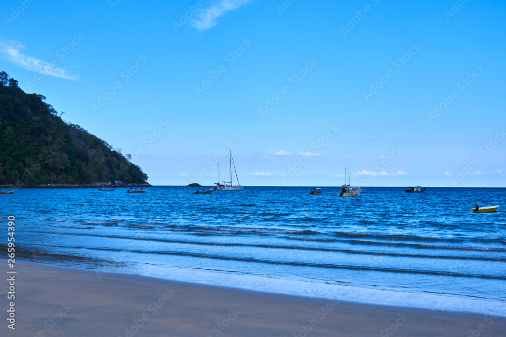 Ocean beach, sea, White clouds with blue sky over calm sea beach in tropical Tioman island, Malaysia. Palm and tropical beach. Summer holiday and vacation concept for tourism. Ocean beach, sea, White clouds with blue sky over calm sea beach in tropical Tioman island, Malaysia. Palm and tropical beach. Summer holiday and vacation concept for tourism.