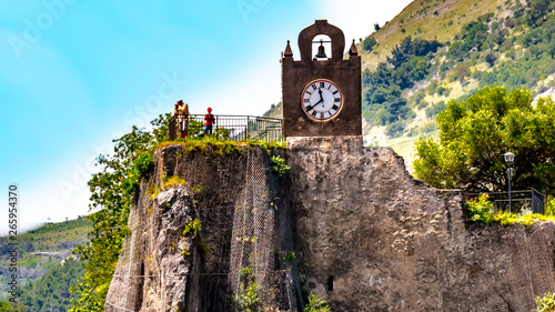 Fotografie Orsomarso, Calabria, Italy - On a promontory stands the Byzantine old church of Santa Maria di Mercure with a clock tower