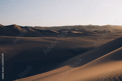 Beautiful sand dunes ripples in the desert  warm dry sand at sunset. Nature landscape. Huacachina desert  Ica Region  Peru. Toned image.