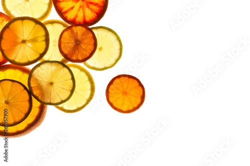 Fototapeta Naklejka Na Ścianę i Meble -  Illuminated slices of citrus fruits on white background, top view