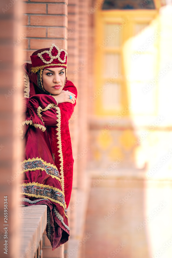 young beautiful iranian lady in a traditional dress, resting 