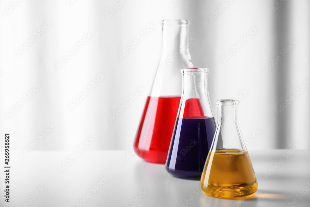 Different glassware with samples on table in chemistry laboratory. Space for text Different glassware with samples on table in chemistry laboratory. Space for text