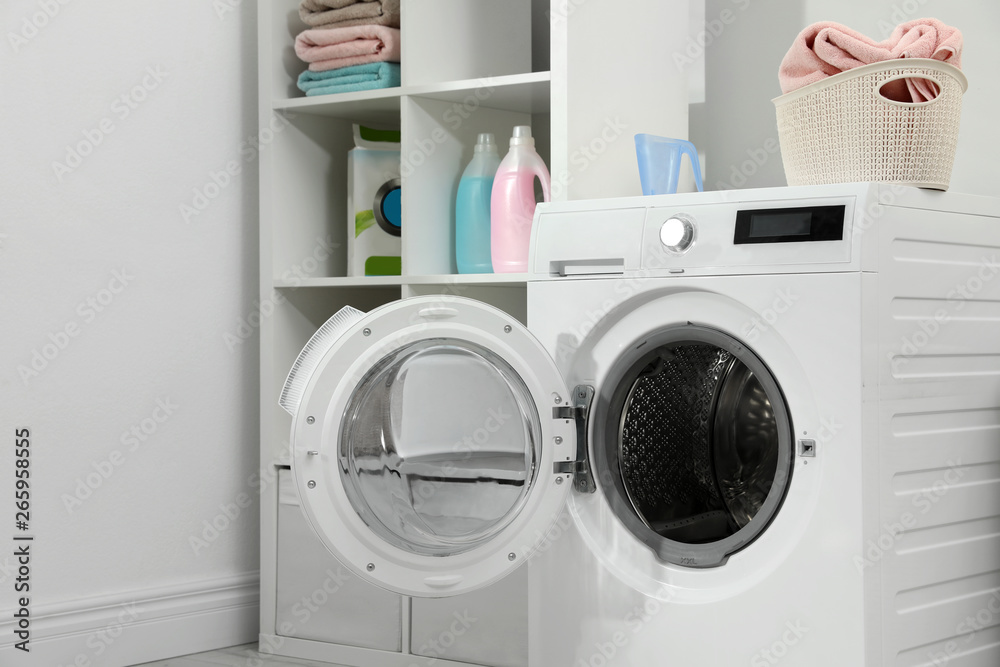 Modern washing machine in laundry room interior Modern washing machine in laundry room interior