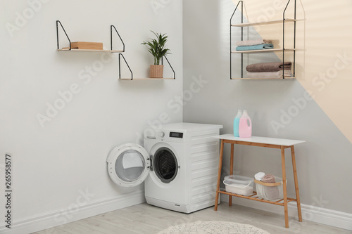 Modern washing machine in laundry room interior © New Africa