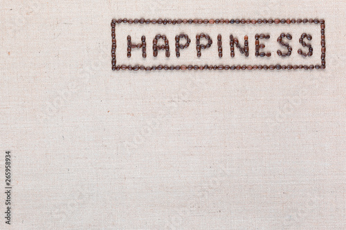 Happiness sign from coffee beans on linea texture, aligned top right.