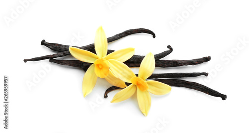Aromatic vanilla sticks and flowers on white background photo