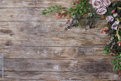 Background of brown wooden planks and flowers.