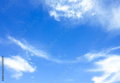 Sky background is vast with white clouds.