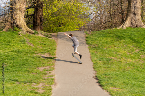 Young boy playing Skateboard in the park in summer. photo