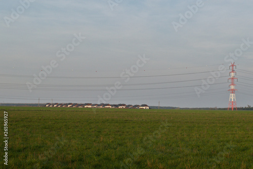 New housing estate in the fields with overhead power line, Poznań, Poland