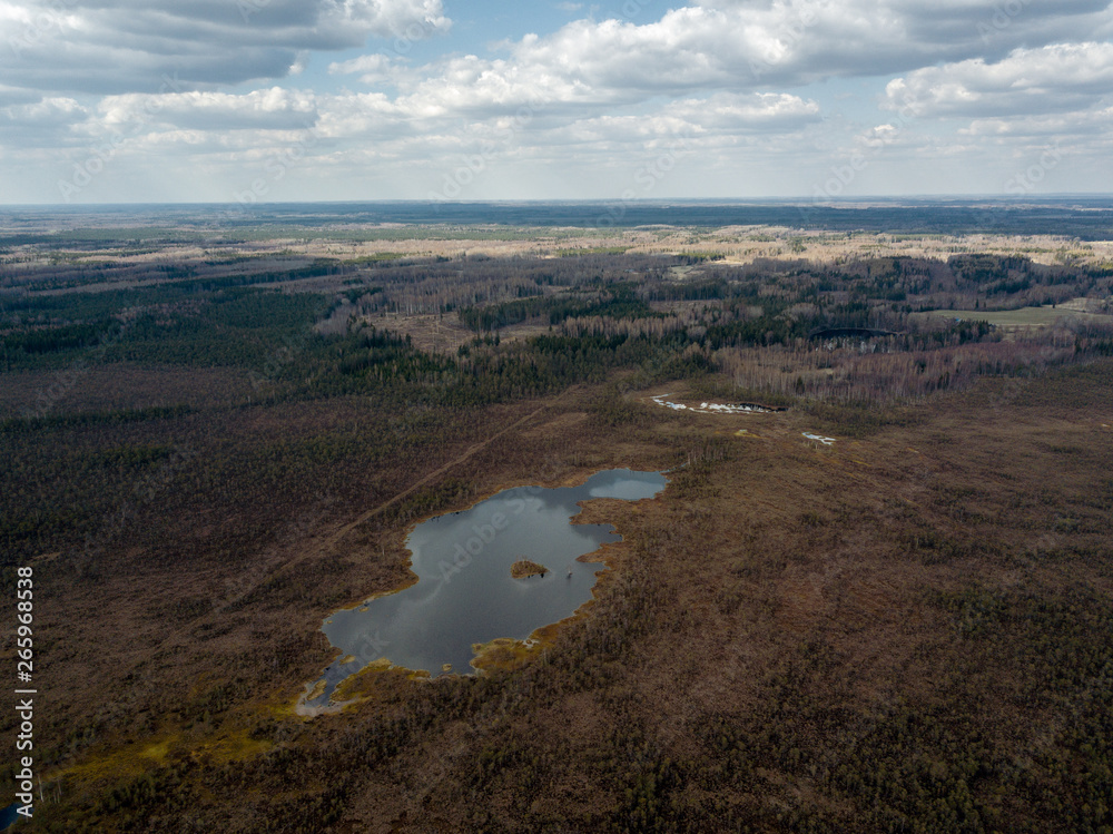 aerial view of countryside fields and forests with small lakes aerial view of countryside fields and forests with small lakes