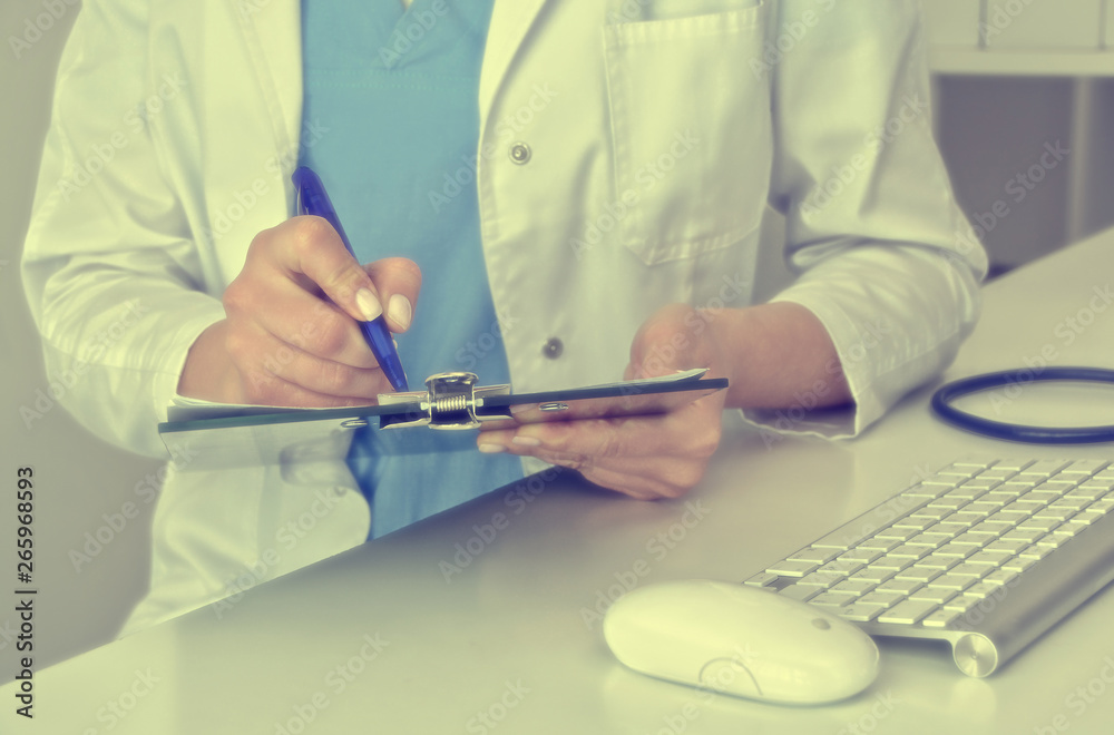 Matte background. Medical content. Doctor writes a prescription of medicine. Medical office in a clinic. Physician. Healthcare. Treatment. Paperwork. Copy space for your text. Matte background. Medical content. Doctor writes a prescription of medicine. Medical office in a clinic. Physician. Healthcare. Treatment. Paperwork. Copy space for your text.