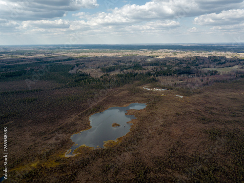 aerial view of countryside fields and forests with small lakes