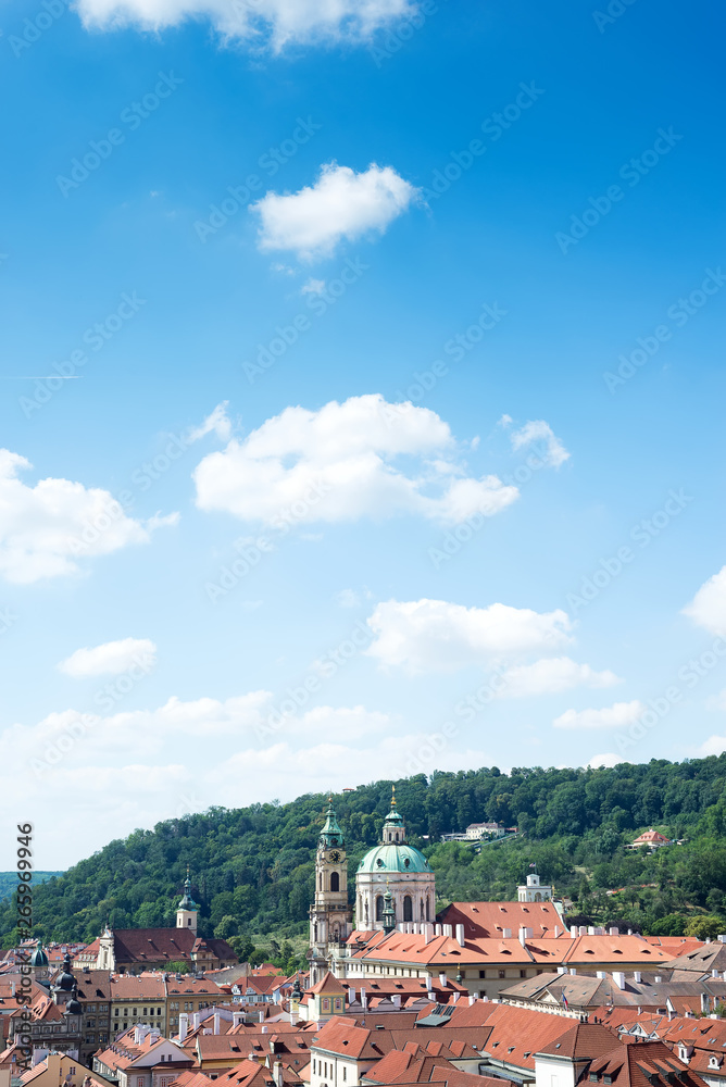Cityscape with blue sky of Praha roofs and St. Nicholas Church in Mala Strana, Prague, Czech Republic