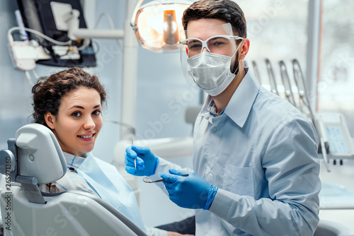 Beautiful woman patient having dental treatment at dentist's office. Woman visiting her dentist.