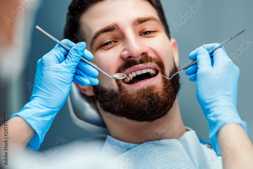 Man having teeth examined at dentists. Close up view.