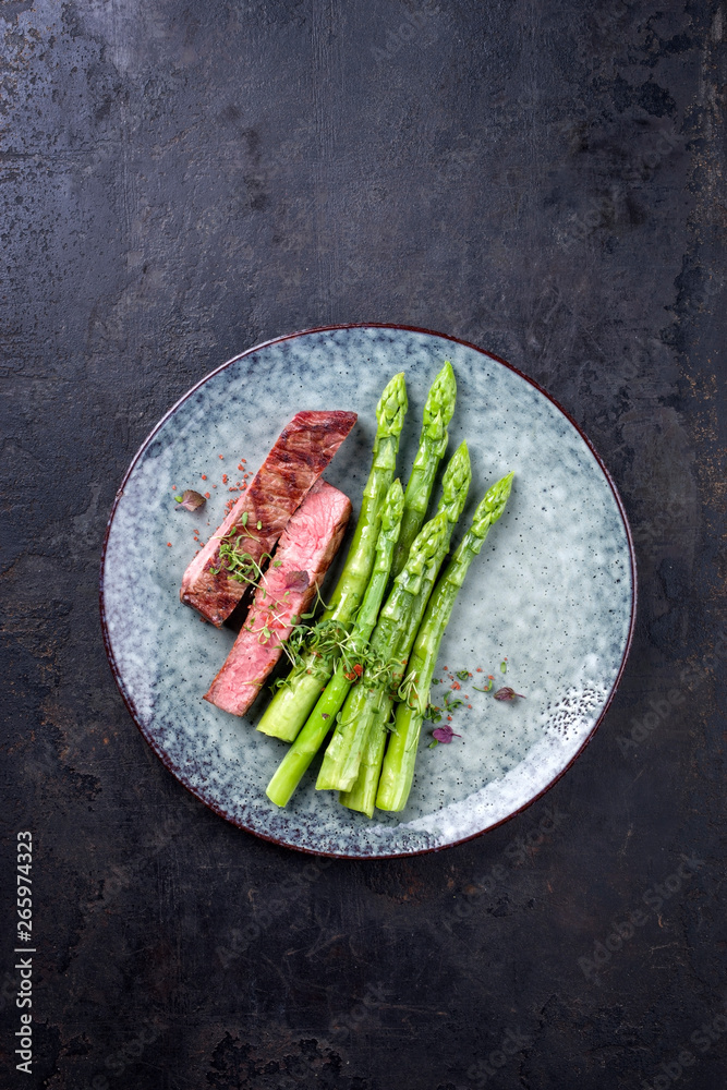 Barbecue dry aged wagyu roast beef steak with blanched green asparagus ...