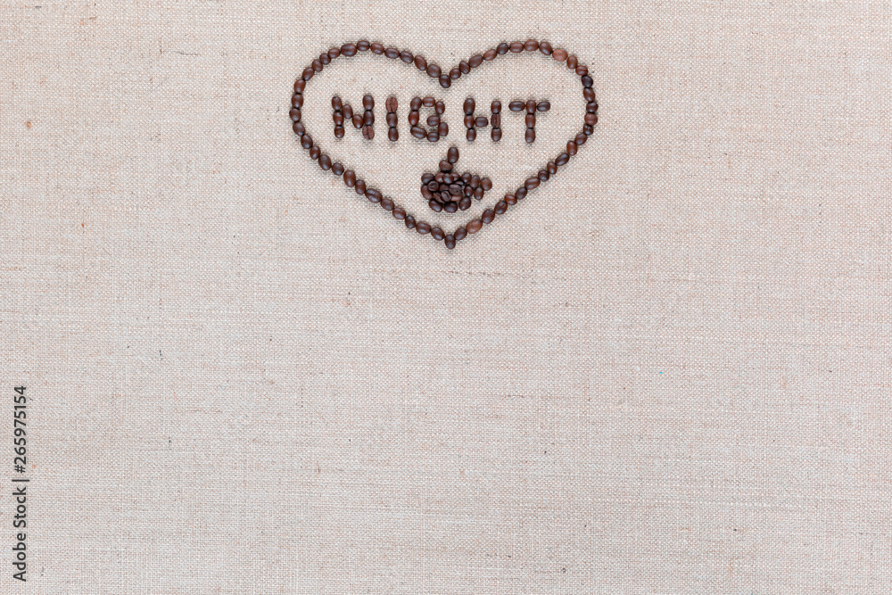 Night in heart sign from coffee beans isolated on linea texture, aligned top center.