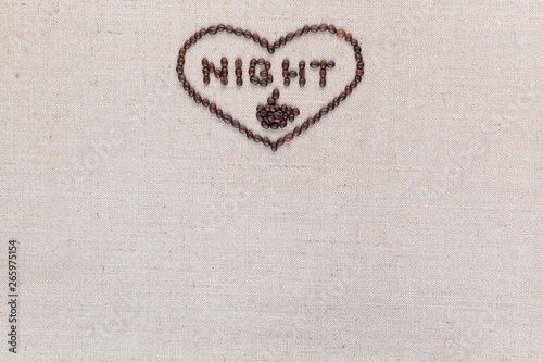 Night in heart sign from coffee beans isolated on linea texture, aligned top center.