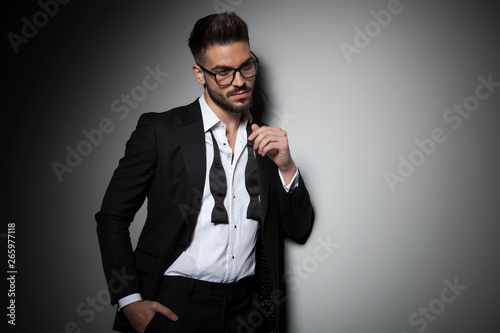 attractive man in tuxedo holding hand in pocket