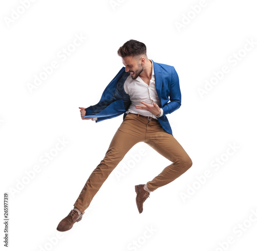 side view of business man in suit jumping and screaming