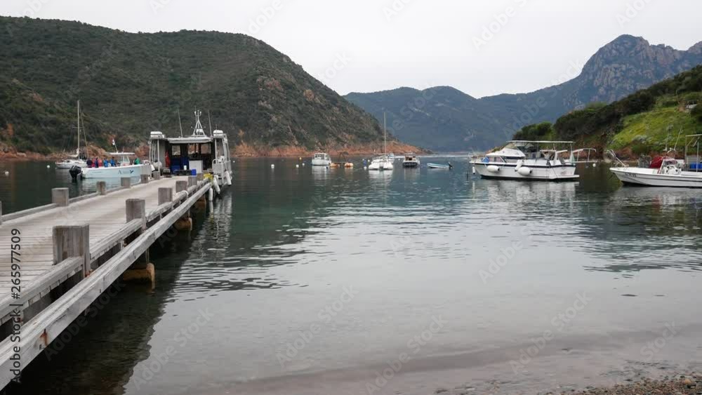 Girolata, Corsica Regional Park, France - april 20 2019: fishing village of Girolata and port with typical red cliffs of volcanic origin. Scandola Nature Reserve a Natural World Heritage Site Girolata, Corsica Regional Park, France - april 20 2019: fishing village of Girolata and port with typical red cliffs of volcanic origin. Scandola Nature Reserve a Natural World Heritage Site