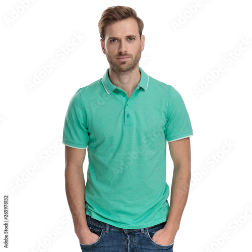 handsome man standing with hands in pockets