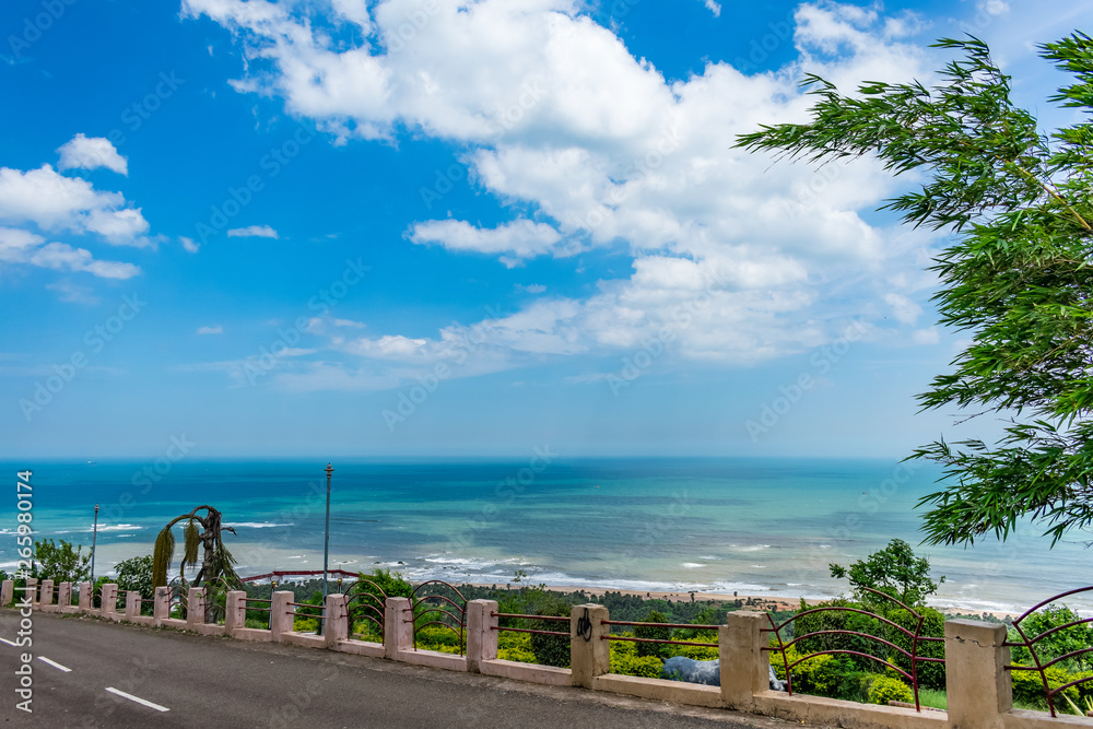 Awesome view of sea beach & blue sky scenery from a resort hotel parking road.
