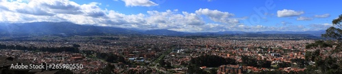 Fototapeta Naklejka Na Ścianę i Meble -  Panoramic view of a large city, Cuenca, with mountains and clouds in the background