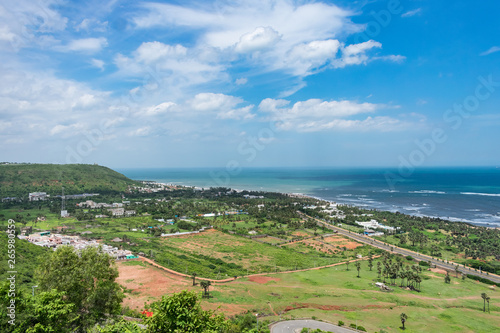 top view of sea beach road looking awesome from top of a mountain with blue sky & beautiful sea view. © Mayank