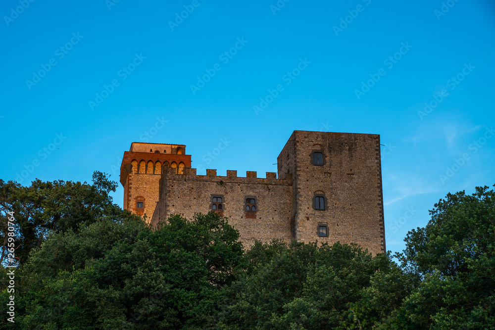 Medieval building of San Gimignano old town with towers, bright blue sky in the background, typical Italy and Tuscany countryside landscape.