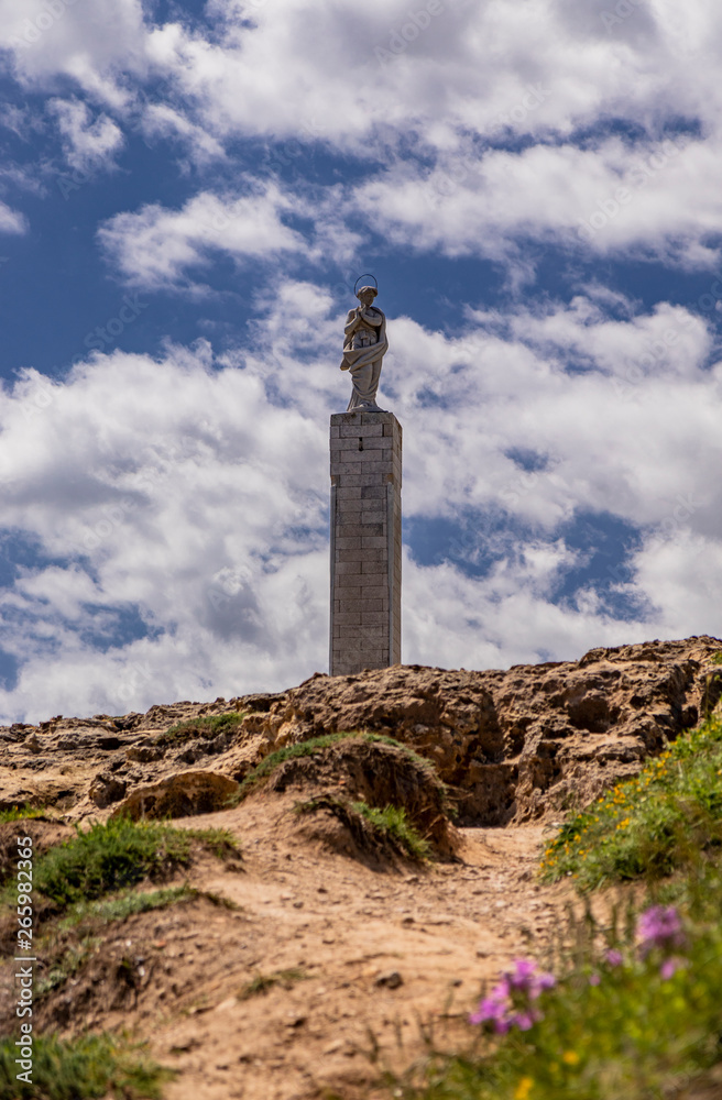 The important archaeological site and tourist resort of Roca Vecchia, in Puglia, Salento, Italy. blue sky, rocks, sun, lush vegetation in summer. The column of Santa Maria di Roca