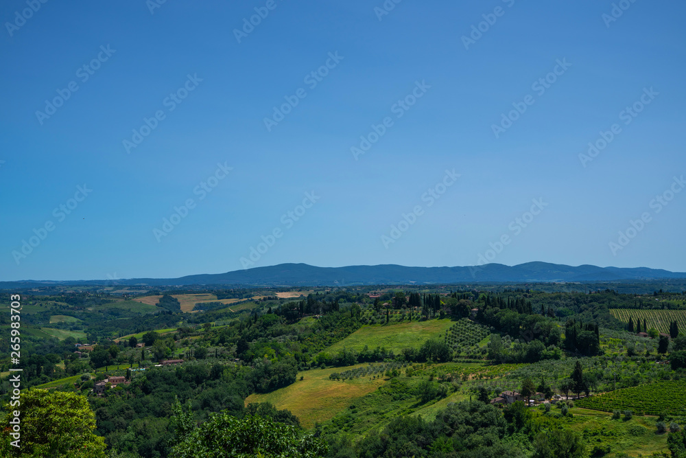 Chianti region in summer season. View of countryside and Chianti vineyards from San Gimignano. Tuscany, Italy, Europe. Travel. Beautiful destination. Holiday outdoor vacation trip.