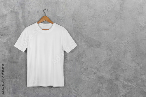 White Blank Cotton Tshirt Hanging Center Gray Concrete Empty Wall Background with clipping path