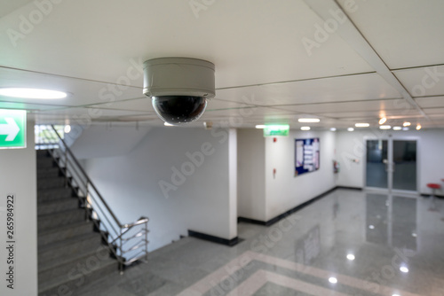 CCTV ip camera hang on the ceiling looking at the stair and access control door for high security safety