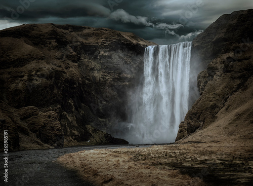 Majestic and dark Skogafoss waterfall in Iceland in a stormy day, moody atmosphere © theartofphoto